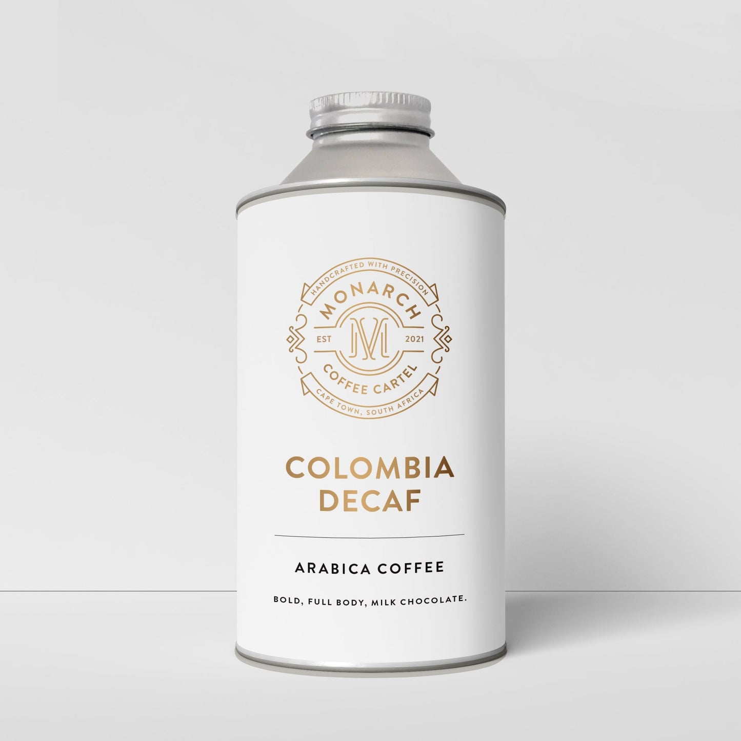 A container labeled 'Colombia Decaf' by Monarch Coffee Cartel, indicating decaffeinated arabica coffee.