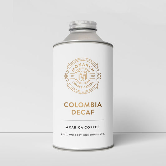 A container labeled 'Colombia Decaf' by Monarch Coffee Cartel, indicating decaffeinated arabica coffee.